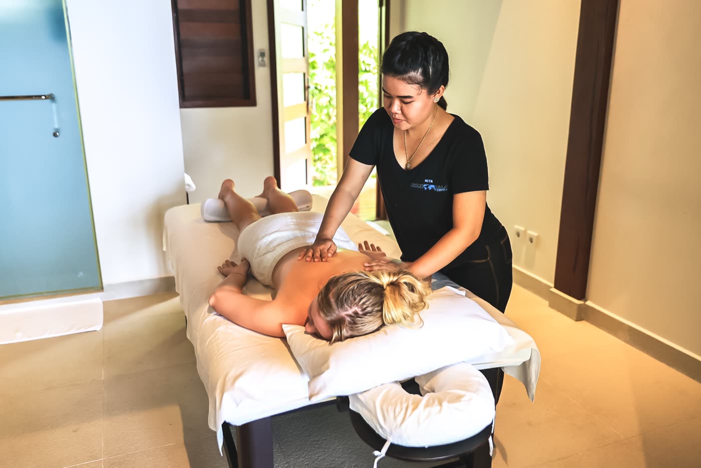 A guest receiving a massage in the spa