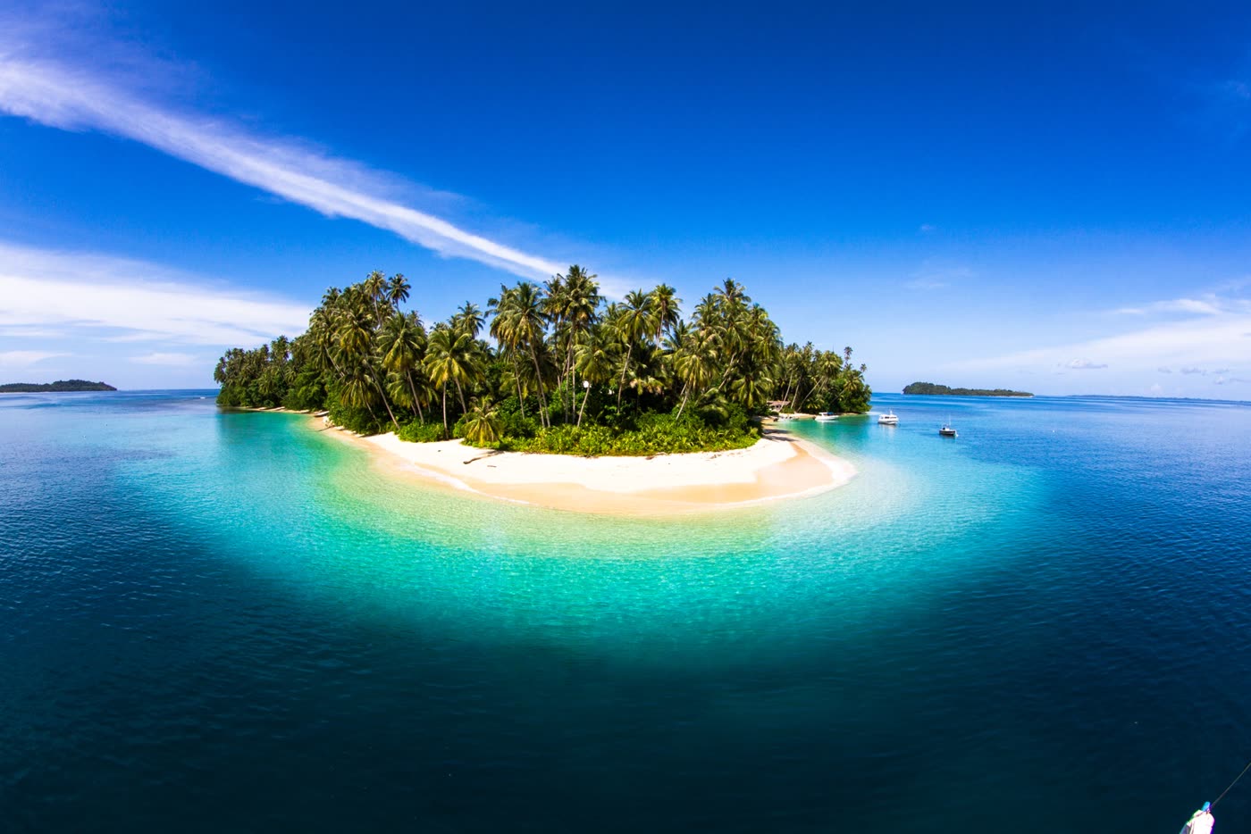 Aerial view of a palm-covered Telo island ringed by turquoise water